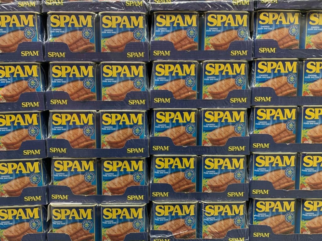 multiple cans of spam as a joke about how vibe coding tools use spammed ai prompts to build apps